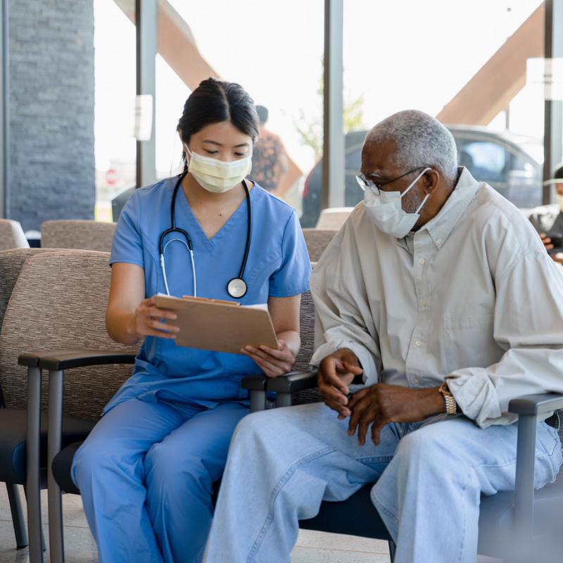 A triage nurse conversing with a patient