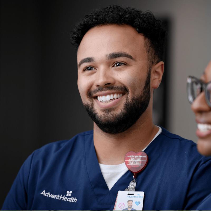 A young male nurse standing with a young female nurse