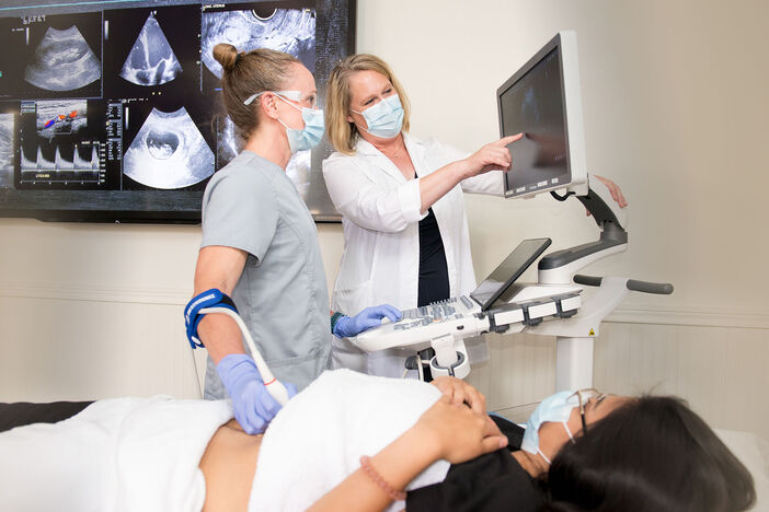 A female student and female teacher practicing sonography skills in the lab