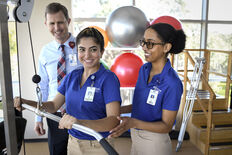 Physical Therapy students using an exercise machine