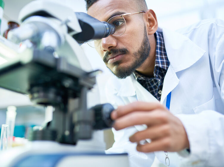 Physician using microscope
