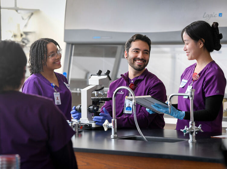 three students smiling in the lab