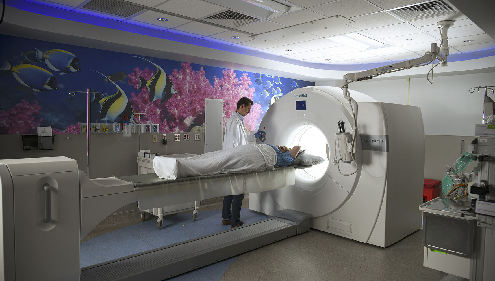 Physician performing PET scan on patient