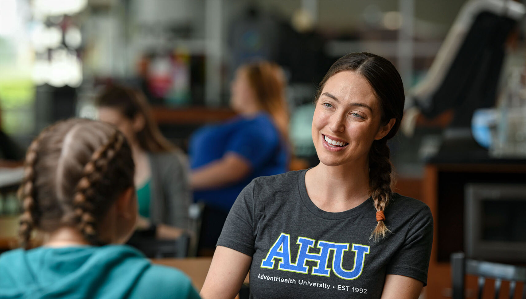 A current student conversing with a new student during orientation