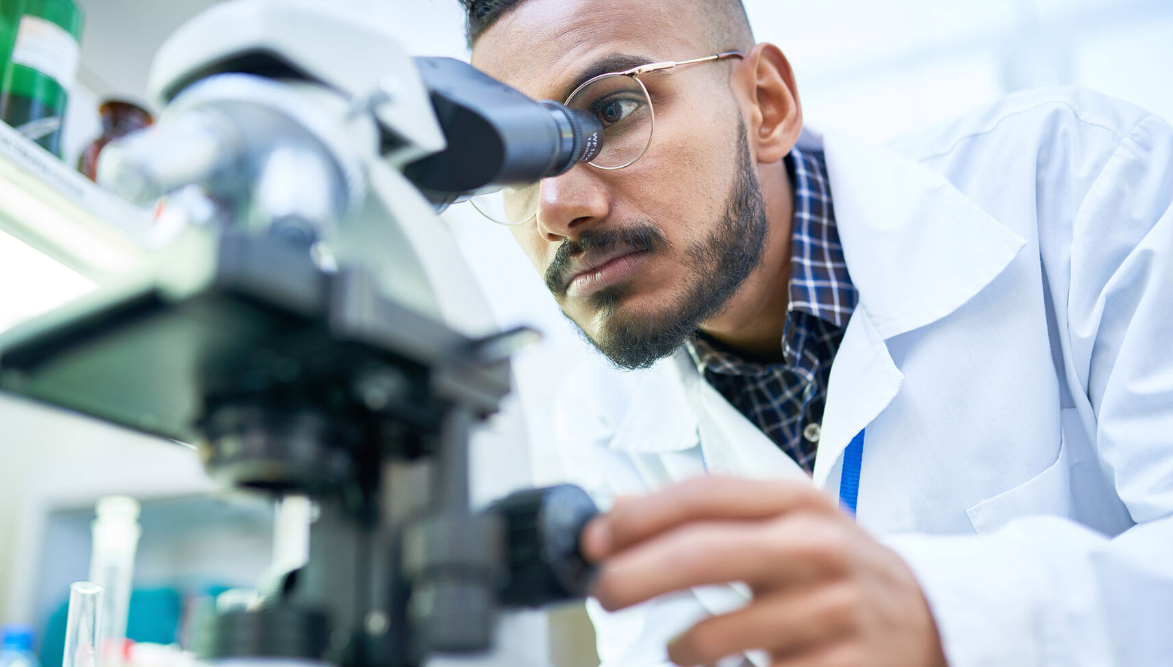 Physician using microscope