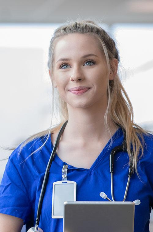 A young female nursing walking through a hospital