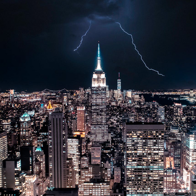 Dramatic view of NY skyline with lightning striking the Empire State Building.