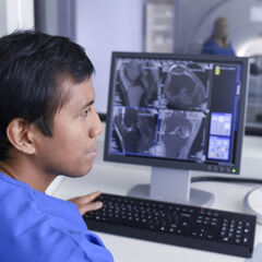MRI Technician using a computer