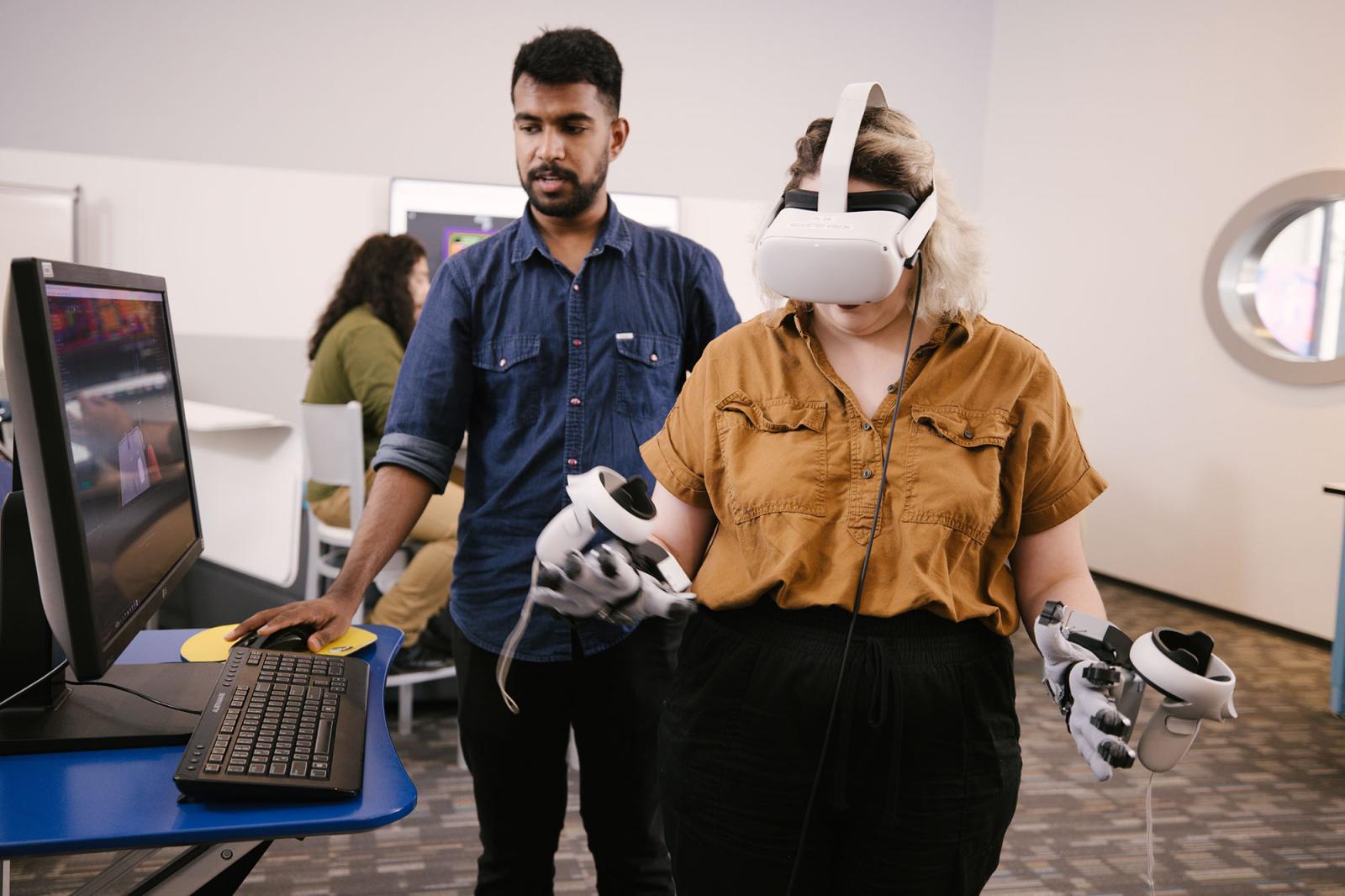 Students using a virtual reality headset and hand-held controls