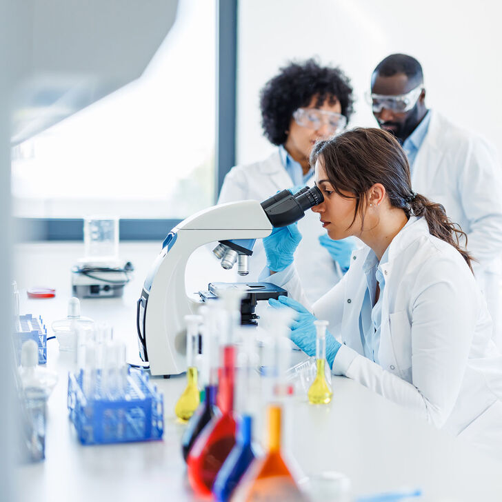 A biomedical scientist uses a microscope