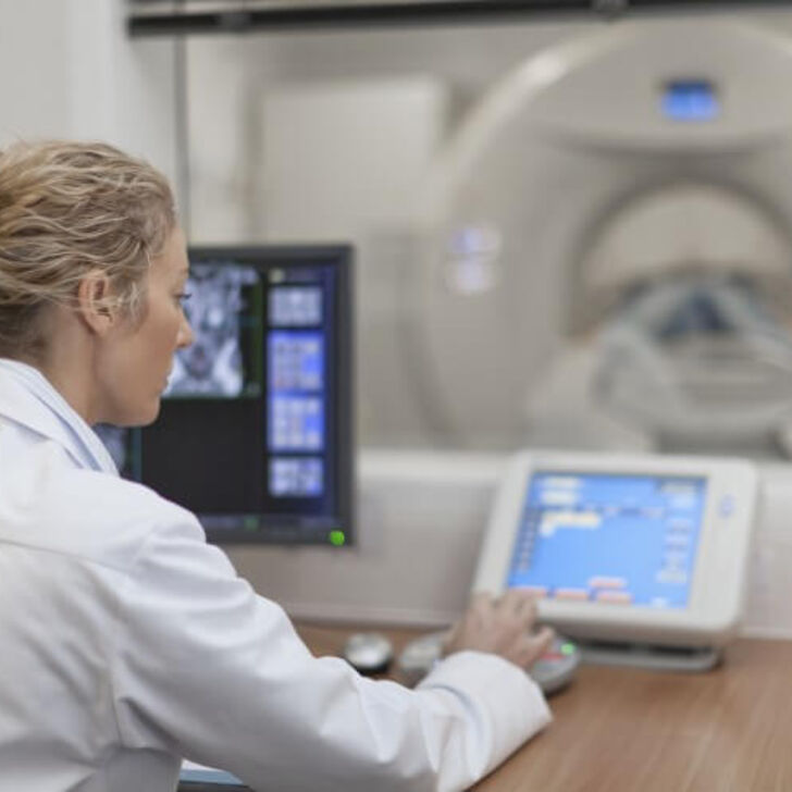A CT tech operating a CT scanner