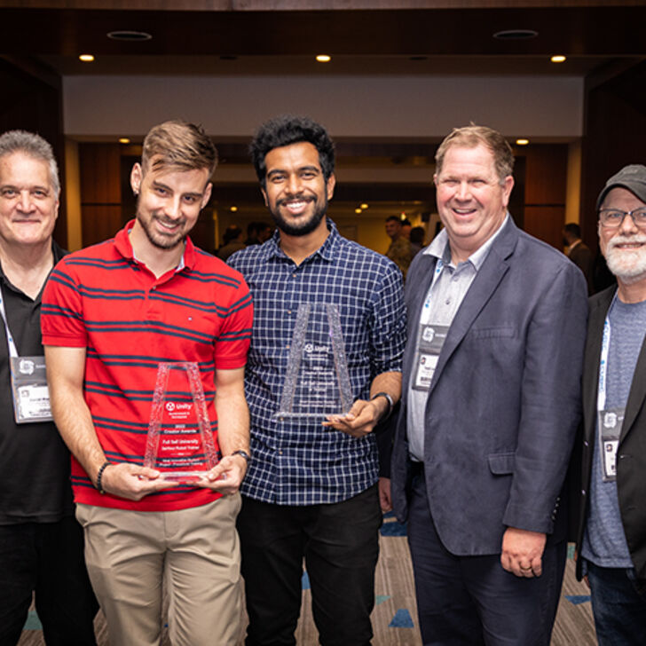 AHU and Fullsail team members poser with awards