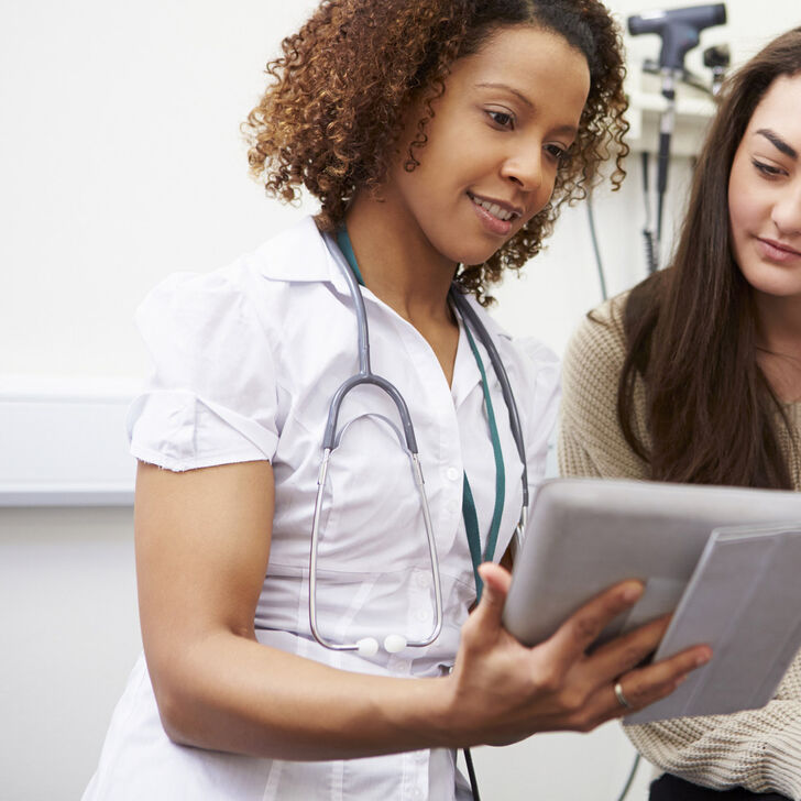 Nurse with patient using tablet