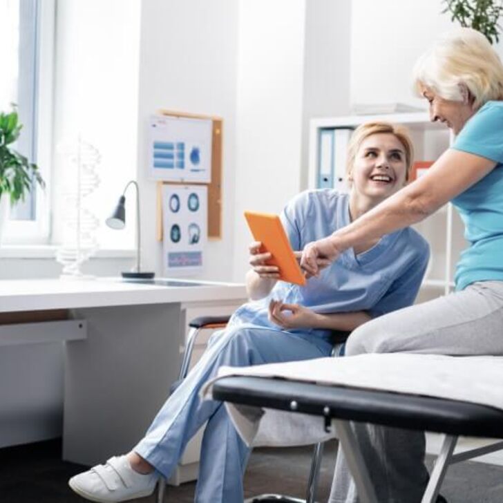 Nurse with patient looking at tablet