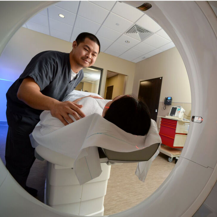 An imaging tech scans a patient