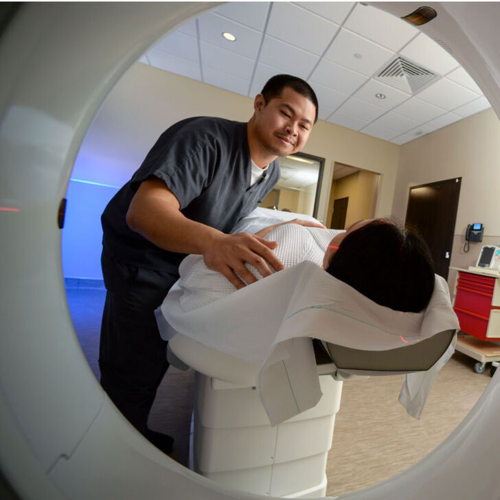An imaging tech scans a patient