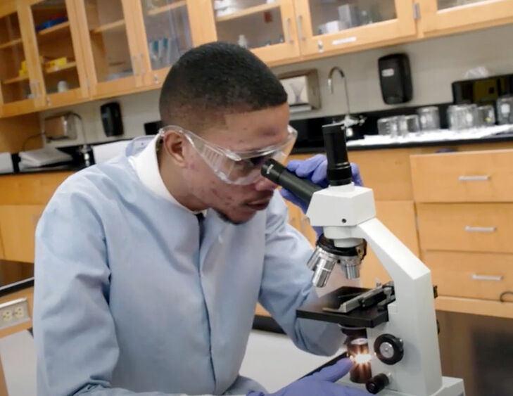 Sean Chin Chan using a microscope