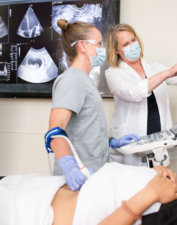 A female student and female teacher practicing sonography skills in the lab