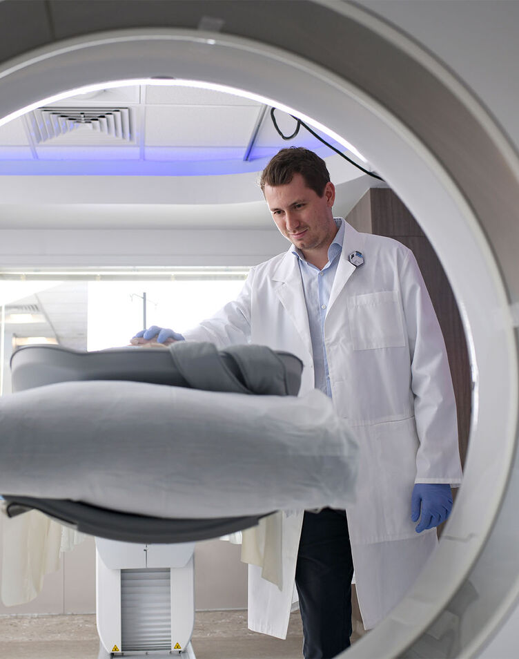 A male nuclear medicine student conducting a PET scan