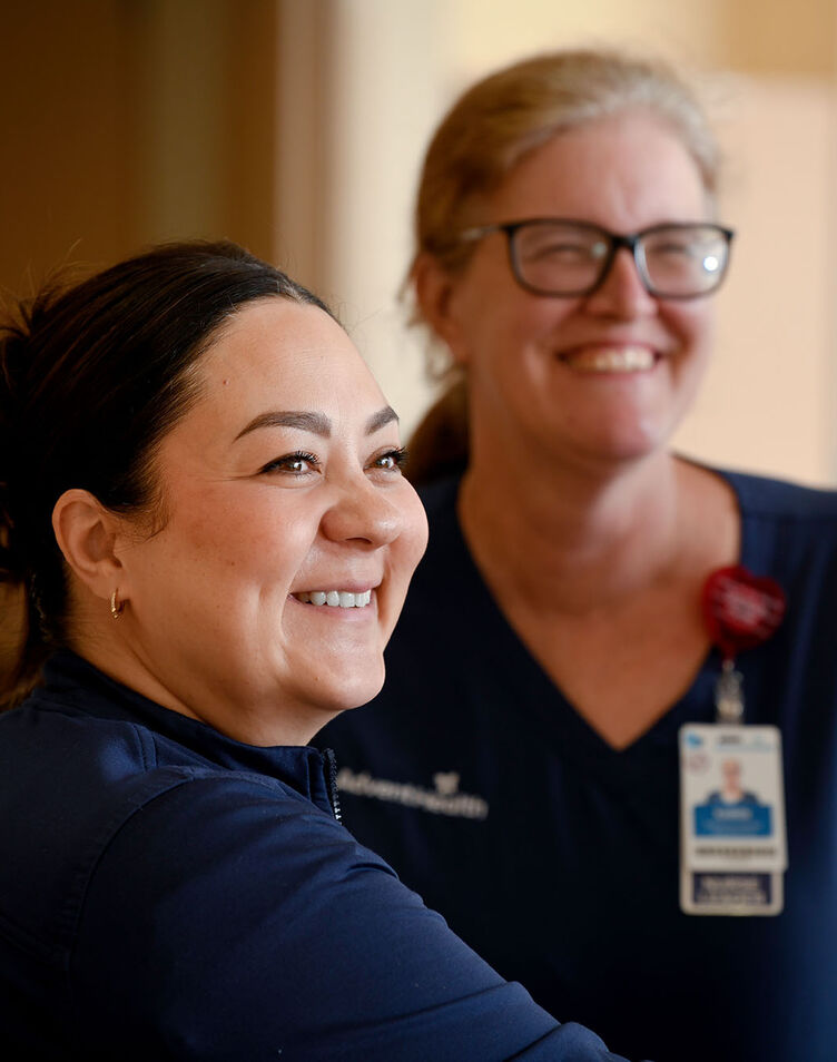 Two older female nurses in a hospital floor