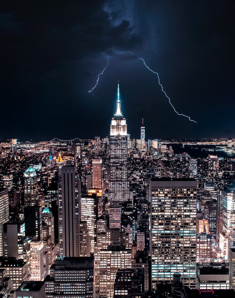 Dramatic view of NY skyline with lightning striking the Empire State Building.